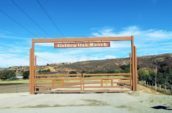Wooden gates are closed with a sign that reads "Golden Oak Ranch"