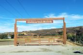 Wooden gates are closed with a sign that reads "Golden Oak Ranch"