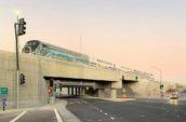 Interstate 5 Freeway at Empire Avenue Interchange Project, a train passes over the bridge as the road below is empty