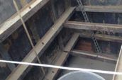 Construction worker works alone in a large concrete culvert ring