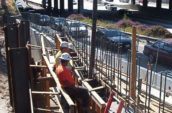 3 construction workers are chatting at the work-in-progress site of State Route 134 & Hollywood Way Interchange Project